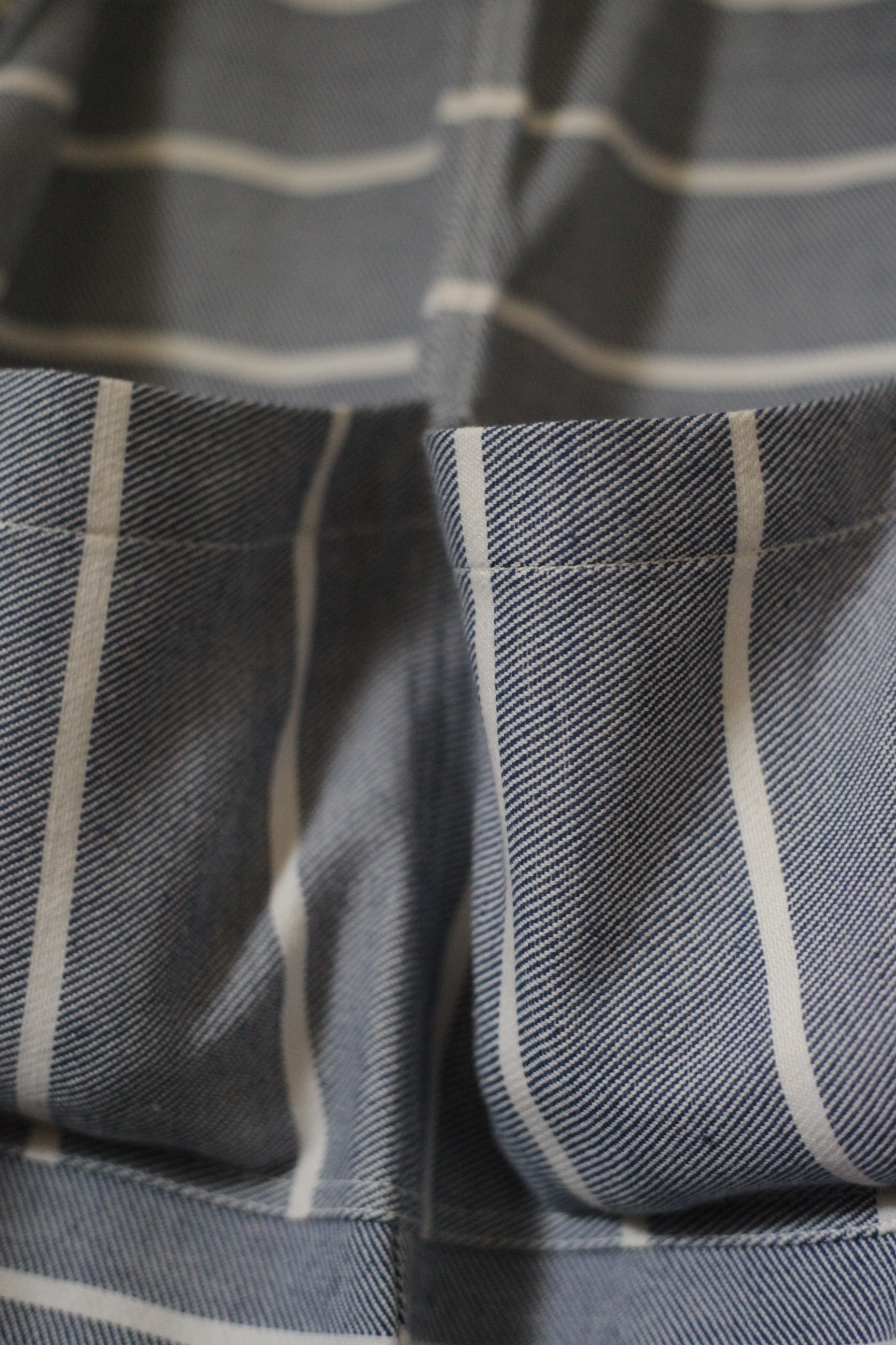 Close-up of a gray and white striped fabric with a label.
